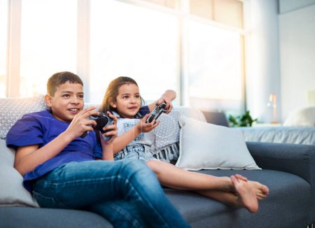 Photo for Kids, siblings and video game with controller, sofa and online for esports in home. Technology, entertainment and virtual challenge for brother and sister, console or couch in living room for fun. - Royalty Free Image