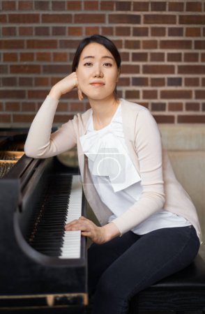 Photo for Asian woman, portrait and musician with piano or confidence for career, music or art with instrument. Female person, musical teacher or acoustic pianist with pride for sound talent, skill or ambition. - Royalty Free Image