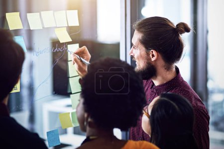 Photo for Businessman, glass and writing for training in office, teamwork and idea for solution. Colleagues, male person and feedback for problem solving, support and coaching for project or brainstorming. - Royalty Free Image