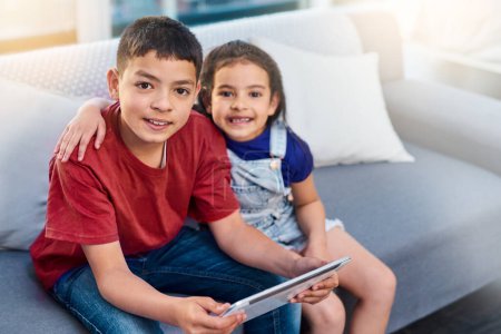 Photo for Tablet, children and portrait with siblings on couch, online and esports for entertainment. Technology, streaming and smile for play on internet in lounge, gaming and digital or mobile on touchscreen. - Royalty Free Image