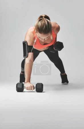 Photo for Push up, arms and woman with weights in studio for health, wellness and body training. Fitness, energy and female athlete with equipment for sports workout or exercise isolated by gray background - Royalty Free Image