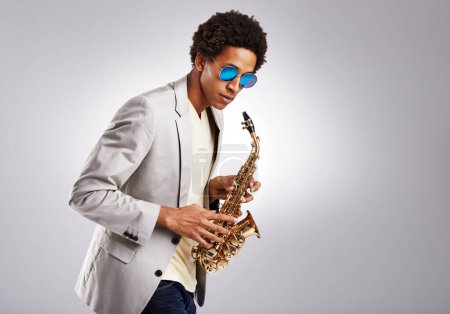 Photo for Saxophone, black man and sunglasses with jazz artist, creative and expression on grey studio background. Person, musician or model with instrument and classic genre with hobby, melody and performance. - Royalty Free Image