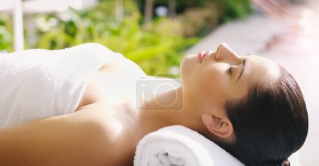 Photo for Beauty, salon and woman relax at spa for massage, facial treatment and luxury pamper. Aesthetic, dermatology and person rest on bed at resort for wellness, cosmetics service and skincare therapy. - Royalty Free Image