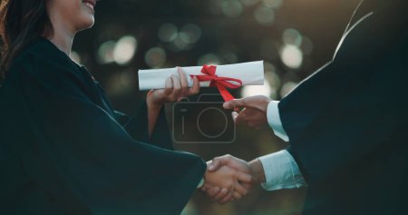 Photo for Hands of people, giving and certificate for graduation on campus, achievement and success with degree. College, graduate or handshake with diploma in education, celebration or ceremony in university. - Royalty Free Image