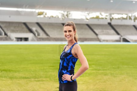 Girl, athlete and happy portrait in stadium for long distance running or sprinting for athletics and training. Female runner, confident and positive for track or field events for olympics in Paris