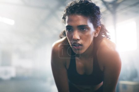 Photo for Sweat, fitness and woman in gym breathe for intense training, exercise and bodybuilder workout. Sports, athlete and person rest, relax and tired for wellness, health and performance in morning. - Royalty Free Image