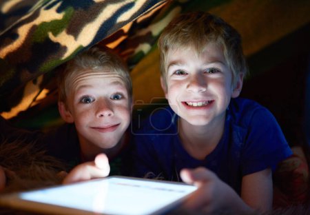 Photo for Portrait, happy kids and brothers on tablet in home tent for game, movie and streaming cartoon online at night together. Face, children and smile of siblings on tech, app or family relax in house. - Royalty Free Image