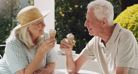 Photo for Senior, couple or ice cream in garden with talk for retirement, planning vacation for anniversary. Husband, wife or old on patio for conversation with gelato, sunshine in summer with partner in home. - Royalty Free Image