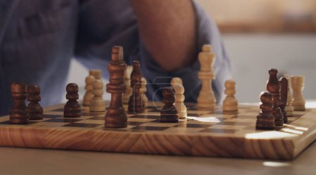 Photo for Game, hands and play of chess, table and board of wood, strategy and challenge for person, house and relax. Home, problem solving and contest or hobby, skill and brain for competition in weekend. - Royalty Free Image