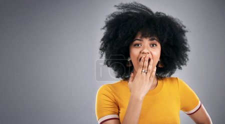 African woman, shocked and portrait in studio for surprise, wow and amazed facial expression. Young person and isolated with hand on mouth for omg, gossip or mind blown announcement or news on mockup.