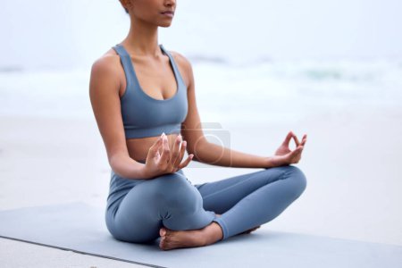 Photo for Yoga, lotus meditation and hands at ocean for mindfulness, peace or calm to relax at sea in nature. Zen, beach and woman in padmasana pose for exercise, fitness and wellness for body health outdoor. - Royalty Free Image