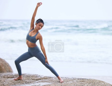 Photo for Beach, stretching and Indian woman doing yoga for spiritual fitness, meditation or wellness. Health, healing and female yogi person for pilates exercise, mindfulness or balanced chi by seaside. - Royalty Free Image