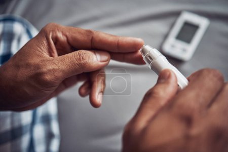 Photo for Person, hand and blood sugar with finger in home for diabetes to monitor insulin, glucometer or test. Medical, pen and safety or health measure as genetic problem or bad diet, wellness or diagnostic. - Royalty Free Image
