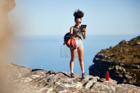 Photo for Mountain, hiking and backpack of woman with tablet for travel guide, networking or fitness blog update. Black person, health and exercise with technology for tourism, information or adventure in Peru. - Royalty Free Image