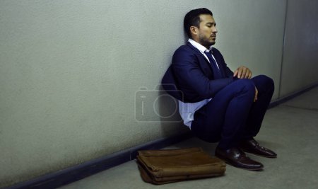 Photo for Businessman, fired and depression on floor at workplace with unemployment, fail and mockup space. Professional, employee and concerned in corridor of office building with bag, leaving and helpless. - Royalty Free Image