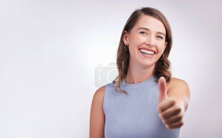 Photo for Thumbs up, agreement and portrait of happy woman in studio mockup with positive attitude. Thank you, smile and girl with yes hand gesture for success emoji, praise and achievement on white background. - Royalty Free Image
