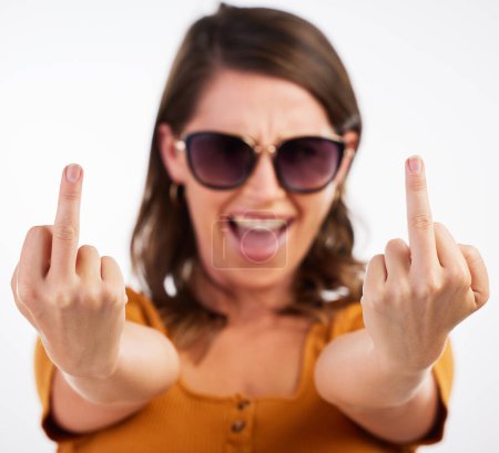 Photo for Woman, portrait and sign with middle finger for expression or flipping off on a white studio background. Face of Female person, young rebel or wild and free in showing emotion, emoji or funny gesture. - Royalty Free Image