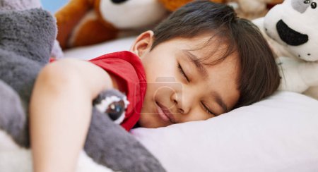 Photo for Asian boy, baby and sleeping in bedroom, home and nursery for peace, calm and dreaming at nap time. Tired, toys or young male kid resting for break, growth and healthy childhood development in house. - Royalty Free Image