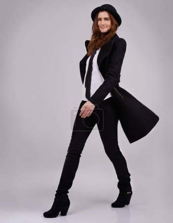 Fashion, woman and suit with hat in studio for gender neutral, y2k and edgy with designer brands. Confident, vintage and elegance by white background for style inspo, minimalist and funky apparel.