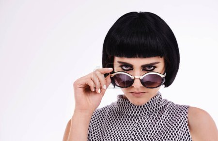 Photo for Fashion, portrait and woman in studio for retro, trendy or vintage clothing with white background. Serious, confident and face of female model for aesthetic, designer sunglasses and stylish outfit. - Royalty Free Image