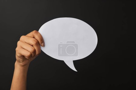 Photo for Hand, speech bubble and announcement in studio for social media, sign or thought for community. Fingers, board and poster on backdrop for digital or billboard, space for idea or advert with internet. - Royalty Free Image