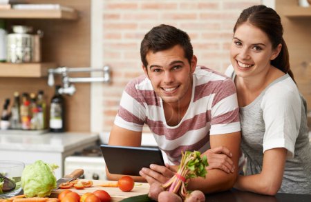 Photo for Cooking, tablet and couple in home portrait for healthy food or vegetables for lunch, steps or dinner recipe. Online, smile and woman in meal prep for salad preparation or hungry vegan man in England. - Royalty Free Image