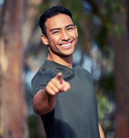 Photo for Man, portrait and pointing to you for fitness choice, outdoors and option or selection in nature. Male person, wellness and motivate for health or training, workout and exercise or emoji for cardio. - Royalty Free Image
