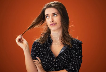 Studio, unhappy and woman with hair, dry and hairloss with spilt ends, aesthetic and treatment for haircare. Red background, mockup and girl with texture, entangled and matted with cosmetics in salon.