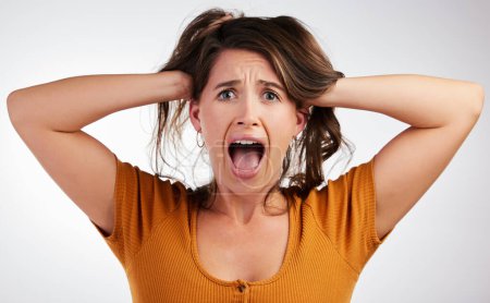 Stress, fear and woman face shouting in studio for anxiety, fail or overthinking on grey background. Trauma, panic or scared model overwhelmed by debt, economy or financial, crisis or inflation news.