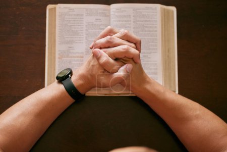 Photo for Top view, praying and man with bible, hands and spiritual with religion and faith for guidance and scripture. Closeup, guy in house and peace with routine and holy book with gratitude and believe. - Royalty Free Image