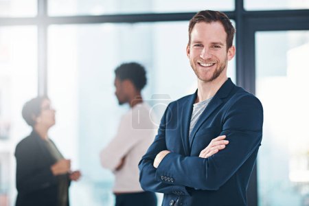 Photo for Confident, man and business with smile in portrait at office, manager or leader near team. Male entrepreneur and colleagues in workplace with mission for growth, contact us for website development. - Royalty Free Image