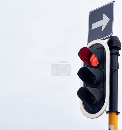 Photo for Traffic lights, stop and signal in urban area for mockup, safety and speed control in the city. Robots, metal and arrow for direction, caution and sign on road for destination and infrastructure. - Royalty Free Image