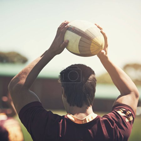 Photo for Athlete, game and rugby ball on field for training, workout and exercise in summer for fitness. Sport, strong man and wellness for challenge, collaboration and back of professional college team - Royalty Free Image