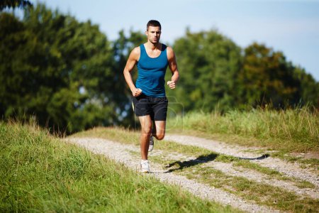 Photo for Sporty, man and jogging in nature for fitness, health and wellness in outdoor for workout or exercise. Male athlete, training and cardio with endurance, muscles and strength for healthy living or gym. - Royalty Free Image