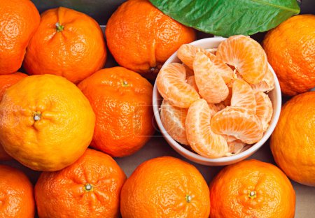 Photo for Fruit, healthy and tangerine slice for diet or weight loss in studio, closeup or zoom and orange. Mandarin, food and group or tropical with vitamin c for wellness, eating and nutrition or natural. - Royalty Free Image