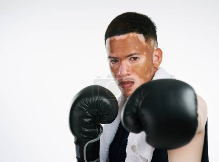 Photo for Serious man, portrait and fighter with boxing gloves or vitiligo for self defense or punch on a white studio background. Male person or young boxer ready for MMA challenge, fight or competition. - Royalty Free Image