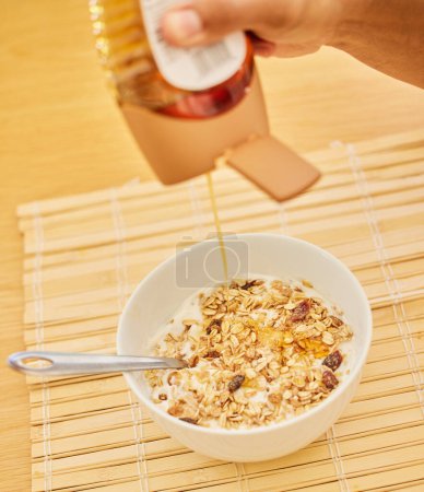 Photo for Honey, hands or closeup of person with cereal, food with muesli for balance, benefits or gut health in home. Hungry, brunch and bowl with vitamins for diet, nutrition or healthy eating at breakfast. - Royalty Free Image