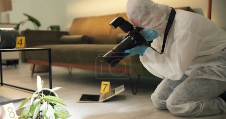 Photo for Csi, photographer and evidence at crime scene for investigation of house burglary or murder analysis. Forensic, person and digital pictures in hazmat for observation, examination and case research. - Royalty Free Image