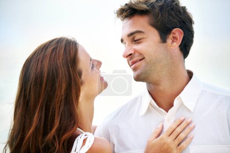 Photo for Couple, outdoor and smile with love, sky and eye contact on summer holiday with connection in nature. Man, woman and trust for bonding, romance or relationship with memory on vacation in Mykonos. - Royalty Free Image