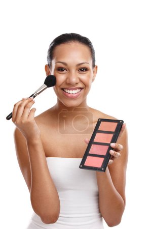 Photo for Woman, portrait and makeup in studio with brush, palette and smile for cosmetics by white background. Happy, tool and face of female model for aesthetic with blush, and glowing skin by backdrop. - Royalty Free Image