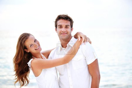 Photo for Happy couple, portrait and hug by ocean in nature, support and relax on honeymoon adventure in outdoor. Young man, woman and face or bonding in marriage, sea and travel on summer holiday in cape town. - Royalty Free Image