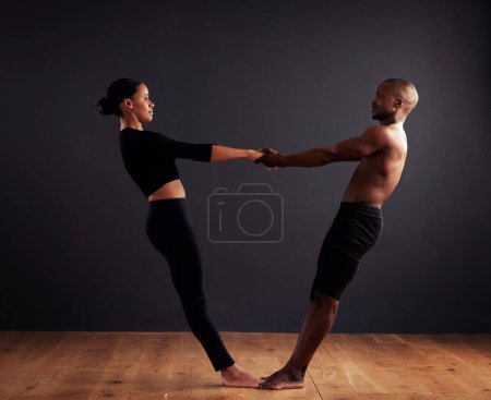 Photo for Performance, theatre and duet of people dancing, creative and art of body, moving and passion. Black background, man and woman with pride, confident and ballet with balance in stage or floor. - Royalty Free Image
