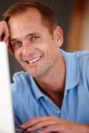 Photo for Man, portrait and laptop in home for work or networking with remote job and creative career in virtual assistance. Male person, digital tech and internet for email or schedule online appointments. - Royalty Free Image