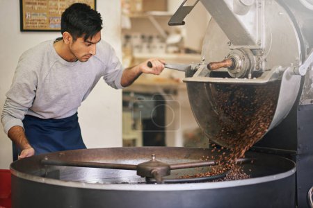 Coffee shop, small business and man at machine for roasting with blending, production or quality control. Entrepreneur, barista or roaster with beans at cafe, sustainable startup and espresso process.