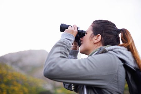 Photo for Woman, binoculars and hiking mountain for nature view on trekking path for explore, adventure or journey. Female person, backpacking and travel workout in wilderness fitness, vacation or environment. - Royalty Free Image