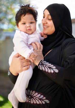 Photo for Baby girl, hug and Muslim mom in hijab outside house for religious celebration, ramadan and young child at home. Islamic female, Arab infant and bonding together in backyard of family dwelling - Royalty Free Image
