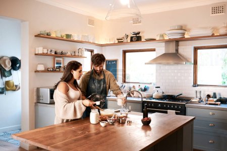 Couple, kitchen and tablet for cooking, online recipe or internet for cake or breakfast indoor. Man, woman and talk with tech for ingredient instruction for bake and fun in relationship on holiday.