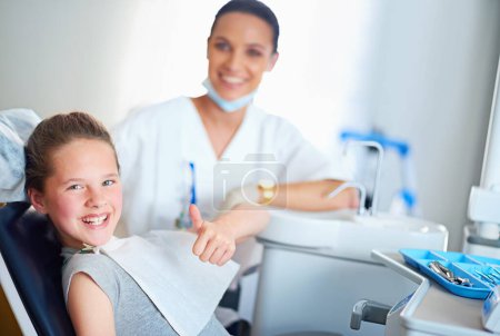 Photo for Thumbs up, dentist and portrait of child in chair for cleaning, teeth whitening and wellness. Healthcare, dentistry and woman and girl with emoji for dental hygiene, oral care and medical services. - Royalty Free Image