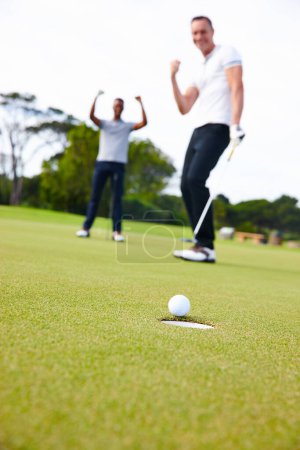 Photo for Happy man, friends and golfer with winner for goal in hole on the green grass or outdoor field in nature. Male person or people in celebration on golf course for winning, victory or ball on target. - Royalty Free Image