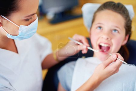 Photo for Woman, dentist and child for cleaning teeth or consultation appointment for cavity health, whitening or examination. Female person, girl and mouth for oral hygiene or gum diagnosis, equipment or care. - Royalty Free Image